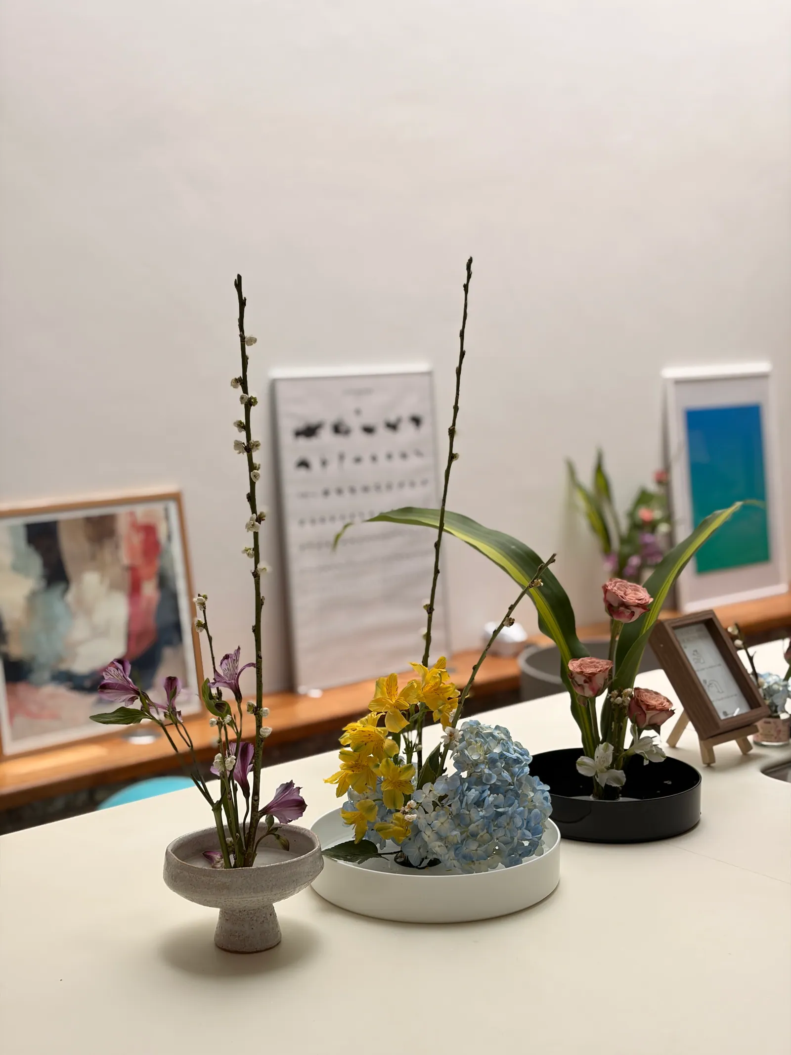 Ikebana arrangement with flowers and stems